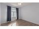 Simple bedroom with wood flooring and a large window at 9336 E Obispo Ave, Mesa, AZ 85212