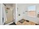 Bathroom with a shower, bathtub, and a window with blinds at 109 E Milada Dr, Phoenix, AZ 85042