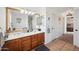 Double vanity bathroom with wood cabinets and a view of the bedroom at 109 E Milada Dr, Phoenix, AZ 85042