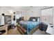 Well-lit bedroom with a wooden bed frame and a desk at 109 E Milada Dr, Phoenix, AZ 85042