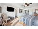 Bedroom with a large TV, sitting chair, and a view of another room at 109 E Milada Dr, Phoenix, AZ 85042