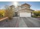Two-story house with a white garage door and landscaping at 109 E Milada Dr, Phoenix, AZ 85042