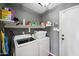 Laundry room with washer, dryer, and shelving for storage at 109 E Milada Dr, Phoenix, AZ 85042