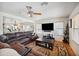 Living room with sectional sofa, coffee table and hardwood floors at 109 E Milada Dr, Phoenix, AZ 85042
