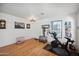 Living room with hardwood floors, exercise bike and pet crate at 109 E Milada Dr, Phoenix, AZ 85042
