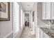 Light and airy hallway with built-in cabinets and access to other rooms at 11175 N 121St Way, Scottsdale, AZ 85259