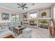 Spacious living room with fireplace, large sectional sofa, and sliding glass doors leading to backyard at 11175 N 121St Way, Scottsdale, AZ 85259