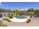 Inviting kidney-shaped pool with a waterfall feature and spacious patio at 11175 N 121St Way, Scottsdale, AZ 85259