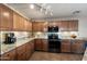 Kitchen with granite countertops, stainless steel appliances, and wood cabinets at 1194 E Lakeview Dr, San Tan Valley, AZ 85143