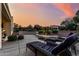 Serene backyard with lounge chairs, lush landscaping, and a retaining wall, offering a private outdoor retreat at 12942 W Sola Dr, Sun City West, AZ 85375