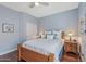 Comfortable bedroom featuring wood floors, ceiling fan, and soft, neutral decor at 12942 W Sola Dr, Sun City West, AZ 85375