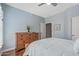 Bright bedroom boasting wood floors, ceiling fan, and neutral color palette at 12942 W Sola Dr, Sun City West, AZ 85375