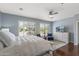 Spacious bedroom features a comfortable bed, a ceiling fan, and bright window shutters for a bright and airy feel at 12942 W Sola Dr, Sun City West, AZ 85375