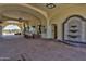 Picturesque arched entrance with outdoor seating and tranquil fountain creating an inviting and serene community experience at 12942 W Sola Dr, Sun City West, AZ 85375