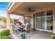 Relaxing covered patio featuring a ceiling fan and sliding glass door at 12942 W Sola Dr, Sun City West, AZ 85375