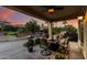 Expansive covered patio featuring comfortable seating and outdoor dining area at 12942 W Sola Dr, Sun City West, AZ 85375