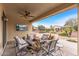 Relaxing covered patio with outdoor seating, ceiling fan, and mounted TV at 12942 W Sola Dr, Sun City West, AZ 85375
