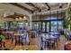Spacious dining area featuring elegant tables, chairs, large windows with views of the golf course, and tasteful decor at 12942 W Sola Dr, Sun City West, AZ 85375