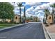 Gated community entrance featuring meticulously maintained landscaping and well-designed architecture with guard houses at 12942 W Sola Dr, Sun City West, AZ 85375