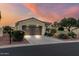 Charming home featuring a tile roof, desert landscaping, and a wide driveway at 12942 W Sola Dr, Sun City West, AZ 85375
