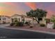 Inviting home exterior with a tile roof, desert landscaping, and a welcoming gated entrance at 12942 W Sola Dr, Sun City West, AZ 85375