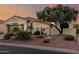 Beautiful home exterior featuring a tile roof, desert landscaping, and gated entrance at 12942 W Sola Dr, Sun City West, AZ 85375