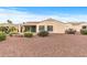 Back exterior showing desert landscaping, windows, and a covered patio area for relaxation and entertainment at 12942 W Sola Dr, Sun City West, AZ 85375