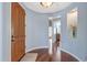 Bright foyer with wood flooring, an arched doorway, and a niche with decorative accents, creating a welcoming entrance at 12942 W Sola Dr, Sun City West, AZ 85375
