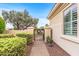 Charming front entrance with a decorative gate and lush landscaping at 12942 W Sola Dr, Sun City West, AZ 85375