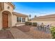 Inviting front yard with a cozy patio area, charming landscaping, and a welcoming entrance at 12942 W Sola Dr, Sun City West, AZ 85375