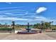Panoramic golf course view featuring lush greenery, water features, and distant mountains under a clear sky at 12942 W Sola Dr, Sun City West, AZ 85375