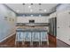 Bright kitchen features a large island, bar seating, stainless steel appliances, and stylish lighting fixtures at 12942 W Sola Dr, Sun City West, AZ 85375