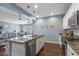 Spacious kitchen offers a large island, stainless steel appliances, and opens to a cozy living area at 12942 W Sola Dr, Sun City West, AZ 85375