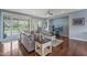 Beautiful living room with hardwood floors, large sectional sofa, an entertainment center and lots of natural light at 12942 W Sola Dr, Sun City West, AZ 85375