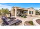 Relaxing covered patio with lounge chairs, outdoor seating, and a mounted television for entertainment at 12942 W Sola Dr, Sun City West, AZ 85375