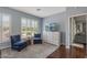 Cozy seating area with two blue armchairs, decorative cabinet, and a large window offering pleasant views at 12942 W Sola Dr, Sun City West, AZ 85375
