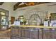 Spa reception area features decorative tiling, a wooden front desk and seating with a relaxing water feature at 12942 W Sola Dr, Sun City West, AZ 85375
