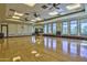 Spacious yoga studio with polished hardwood floors, natural light, and mirrors for an inspiring workout environment at 12942 W Sola Dr, Sun City West, AZ 85375