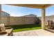 Covered patio with artificial turf and seating area at 14627 W Valentine St, Surprise, AZ 85379