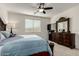 Bedroom with large bed and dresser, ceiling fan at 14627 W Valentine St, Surprise, AZ 85379