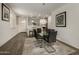 Modern dining room with glass table and six chairs at 14627 W Valentine St, Surprise, AZ 85379