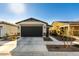 New construction home with a two-car garage and desert landscaping at 14627 W Valentine St, Surprise, AZ 85379
