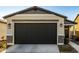 New construction home with two-car garage and neutral color scheme at 14627 W Valentine St, Surprise, AZ 85379