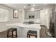 Modern kitchen with gray cabinets, white quartz countertops, and stainless steel appliances at 14627 W Valentine St, Surprise, AZ 85379