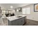 Modern kitchen with gray cabinets, white quartz countertops, and stainless steel appliances at 14627 W Valentine St, Surprise, AZ 85379