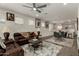 Spacious living room with brown leather couches and a ceiling fan at 14627 W Valentine St, Surprise, AZ 85379
