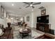 Living room with fireplace, leather furniture, and access to backyard at 14627 W Valentine St, Surprise, AZ 85379