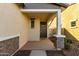 Covered porch with brick columns and a dark brown door at 14627 W Valentine St, Surprise, AZ 85379