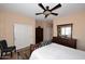 Main bedroom with double doors to closet and wood furniture at 1780 W Morse Dr, Anthem, AZ 85086