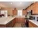 Kitchen with light wood cabinets, stainless steel appliances and breakfast bar at 1780 W Morse Dr, Anthem, AZ 85086